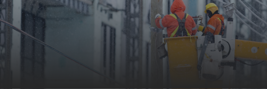 Workers in boom truck working on powerlines.
