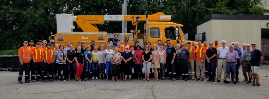 A photo of Festival Hydro Emplyees standing in front of a bucket truck