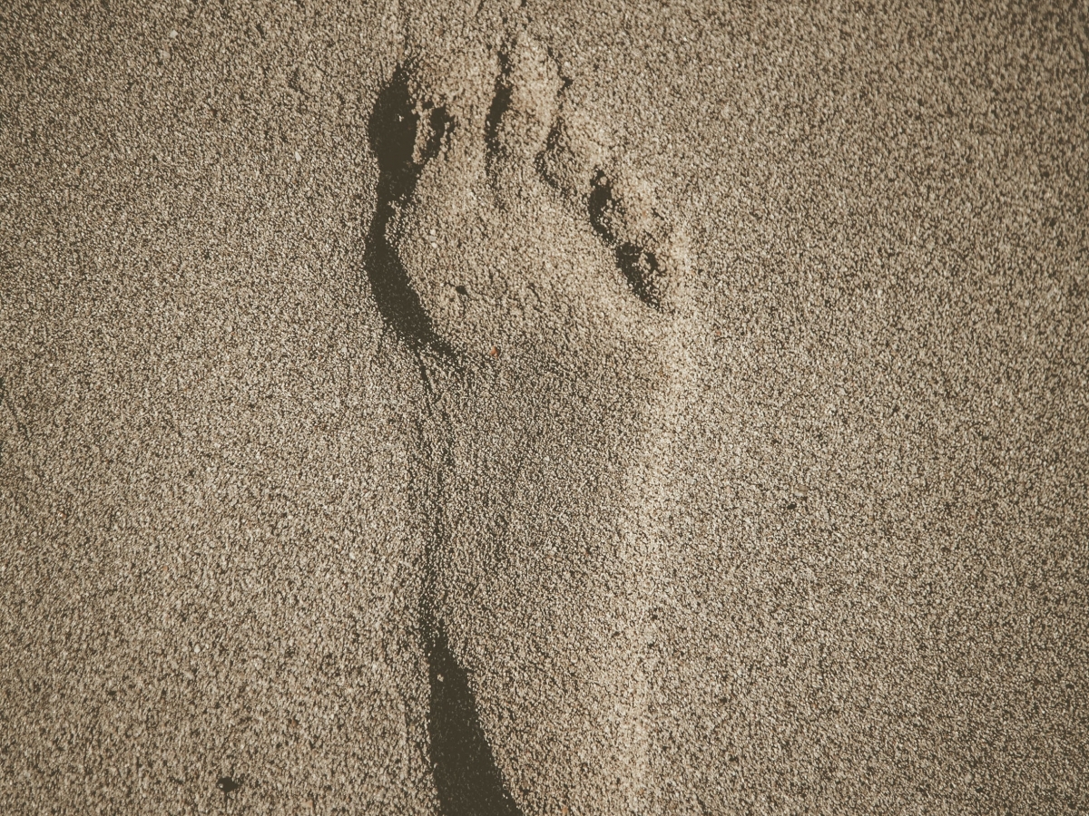Footprint a bare human foot print in brown sand