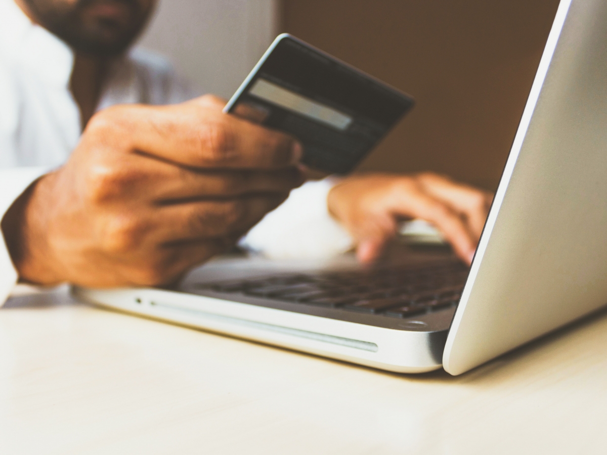 a man is making a payment using a laptop